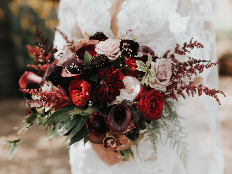Bridal bouquet, bride’s bouquet with flowers done by Sweet Elegance Floral design florist in Kelowna, BC.
Dark, moody, Hollywood glam bouquet of roses, callas, astilbe, roses, dahlias in red, burgundy, purple and cream.
