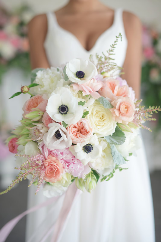 Bridal bouquet, bride’s bouquet with flowers done by Sweet Elegance Floral design florist in Kelowna, BC.
Hand tied summer bouquet with anemones, garden roses, roses, astilbe and peonies in white, cream, pink, peach and purple.
